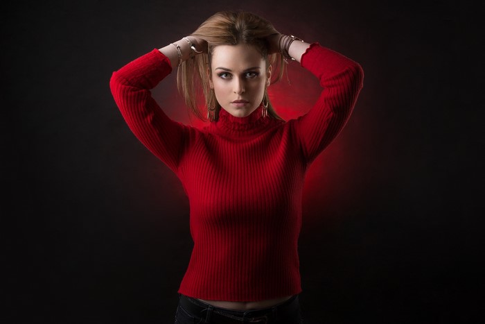 Woman in red sweater posing