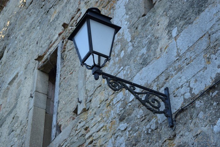 Retro wall lantern on a stone building
