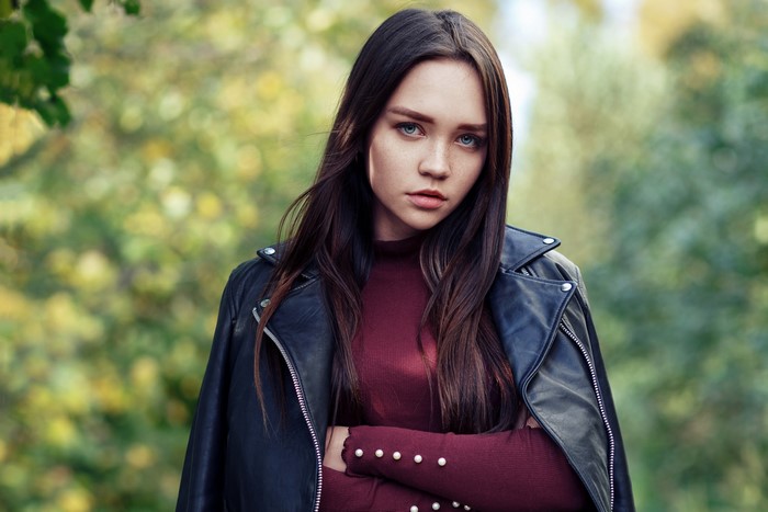 Woman with brown hair wearing a leather jacket