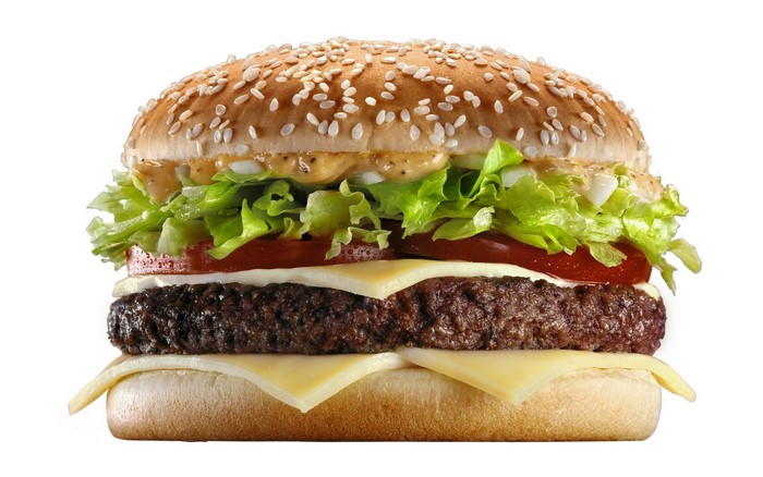 Hamburger with cheese, lettuce, and tomato on a white background