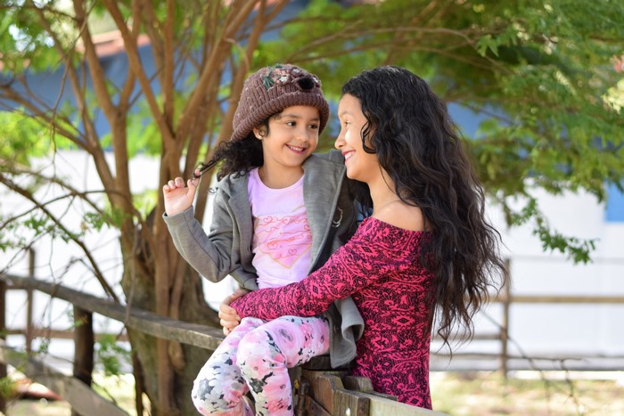 Mother and daughter hugging outdoors
