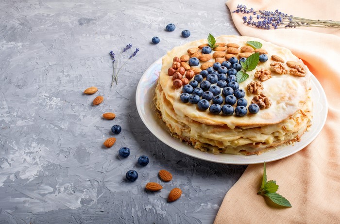 Layered cake with blueberries, almonds, and walnuts