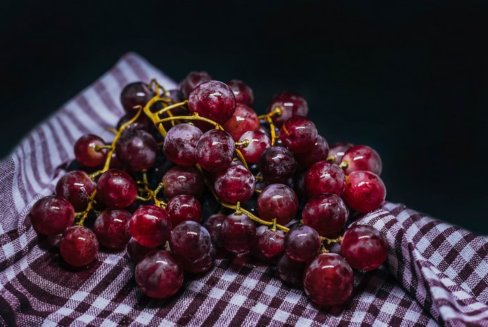 Red grapes on a checkered cloth