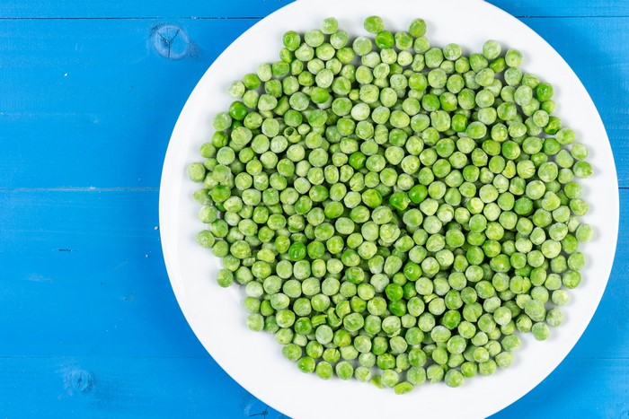 Green peas on a white plate