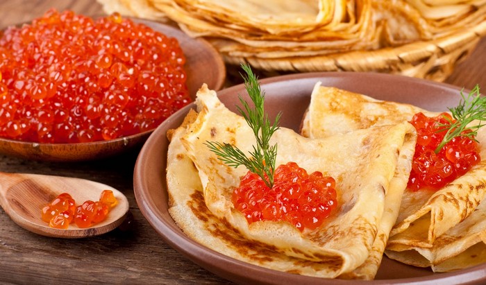 Pancakes with red caviar and dill