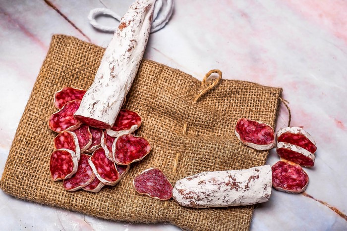Sliced salami on burlap