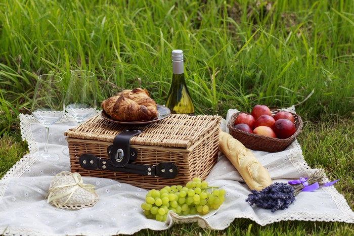 Picnic with wine, fruit, bread, and croissants