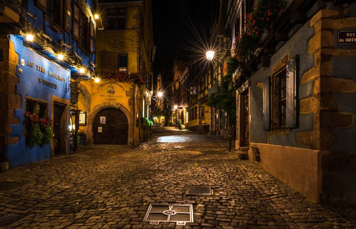 Riquewihr, France street at night with street lights