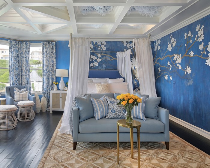 Bedroom with blue floral wallpaper and canopy bed