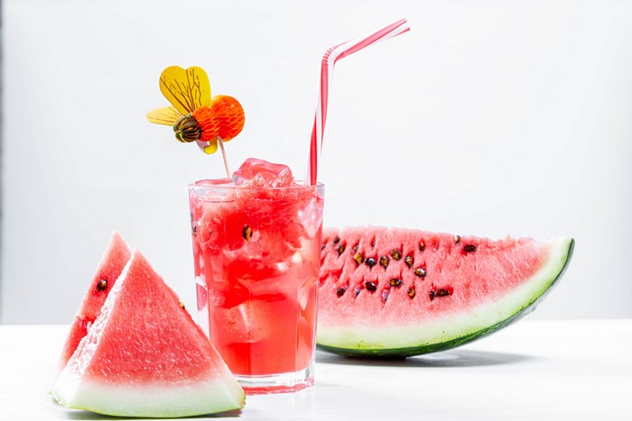 Watermelon juice with bee decoration and slices