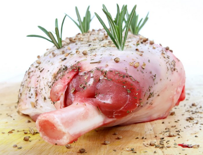 Raw lamb leg with rosemary and spices