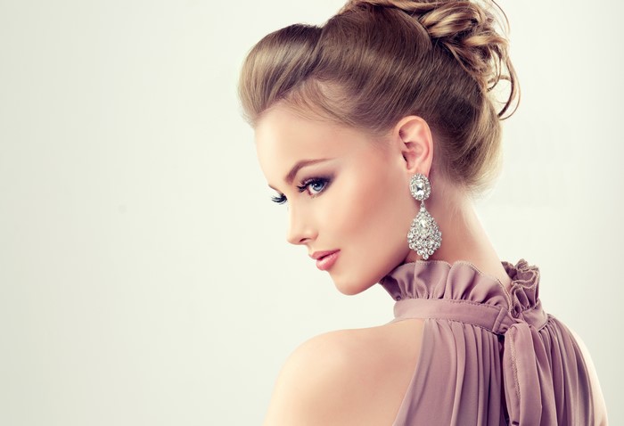 Beautiful woman with elegant hairstyle and diamond earrings