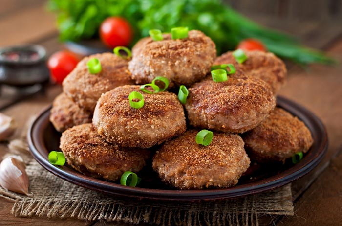 Frikadeller with green onions on a plate