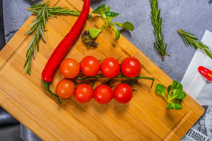 Tomatoes and chili pepper on a cutting board