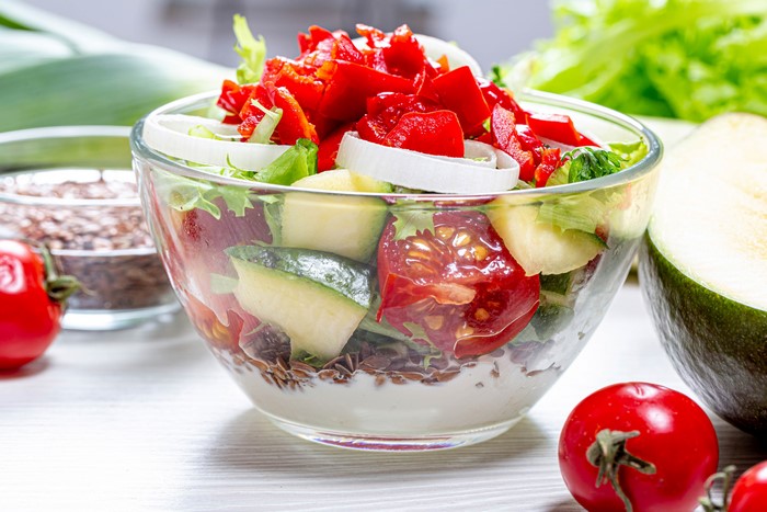 Salad with tomatoes, peppers, and onions in a bowl