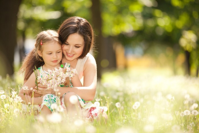 Mother and daughter hugging in a field of flowers