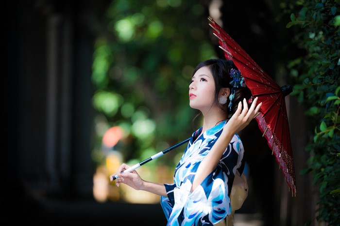 Woman in Kimono holding a red umbrella