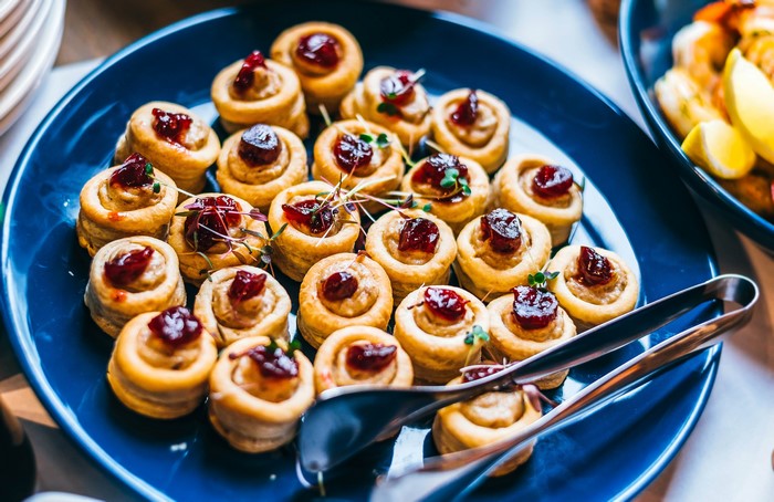Appetizers with jam and filling on a blue plate
