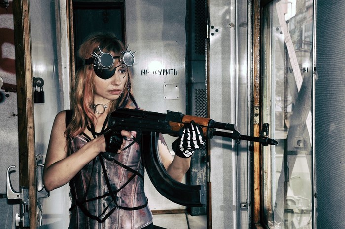 Woman with AK-47 and steampunk goggles