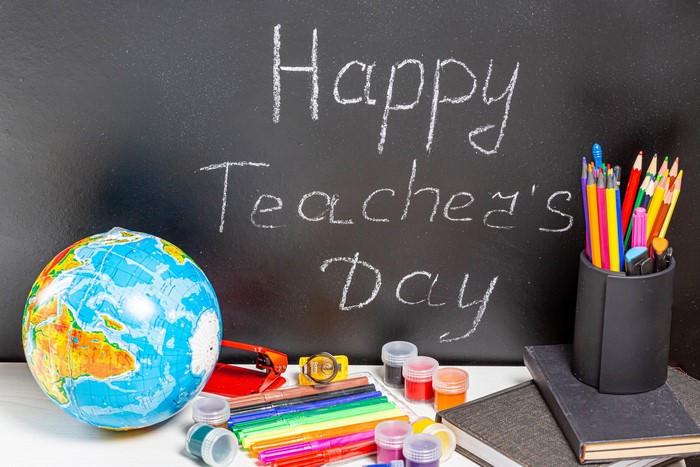 Happy Teacher's Day chalkboard with school supplies