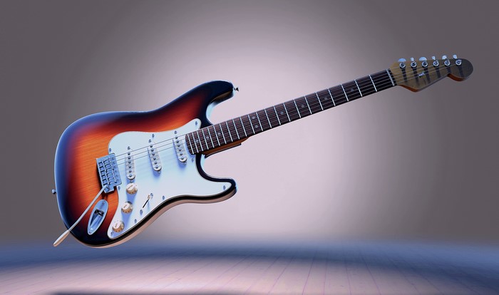 Sunburst electric guitar floating on a wooden floor