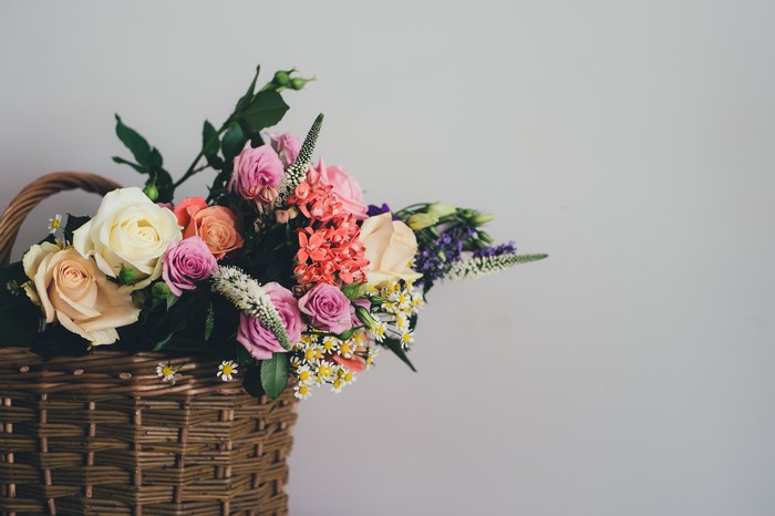 Bouquets in a Wicker Basket on Gray Background