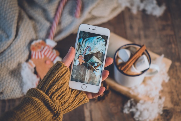 Smartphone showing Christmas scene with hot chocolate