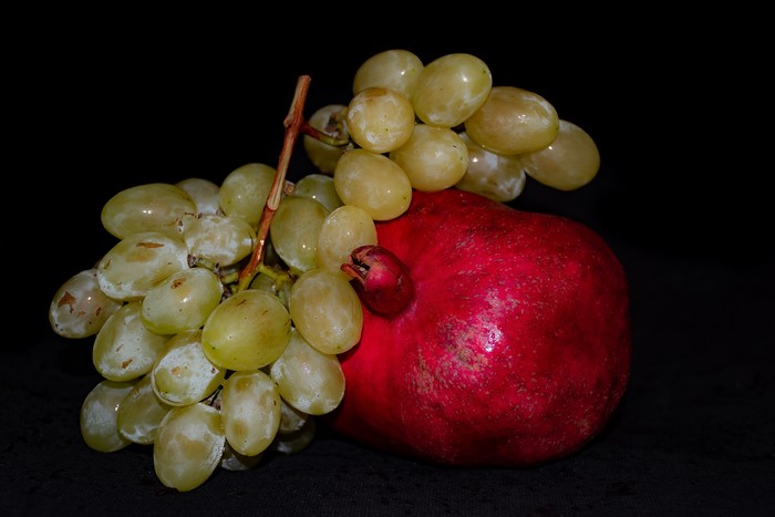 Grapes and Pomegranate on Black Background
