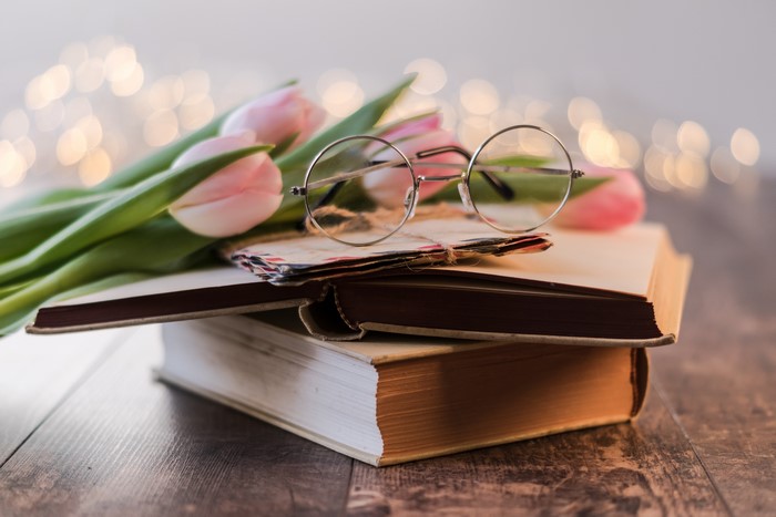 Pink Tulips on Books with Glasses and Bokeh