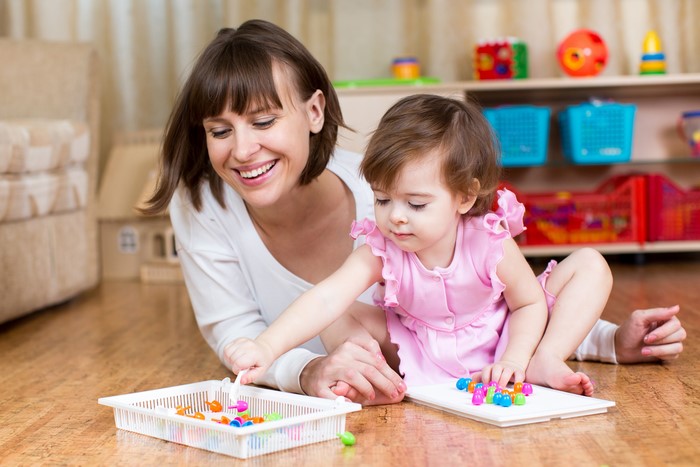 Mother and Daughter Playing with Toys