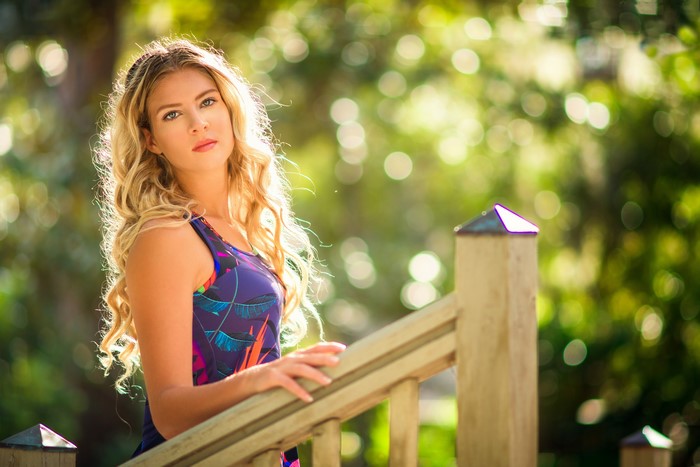 Blonde girl in a dress with bokeh