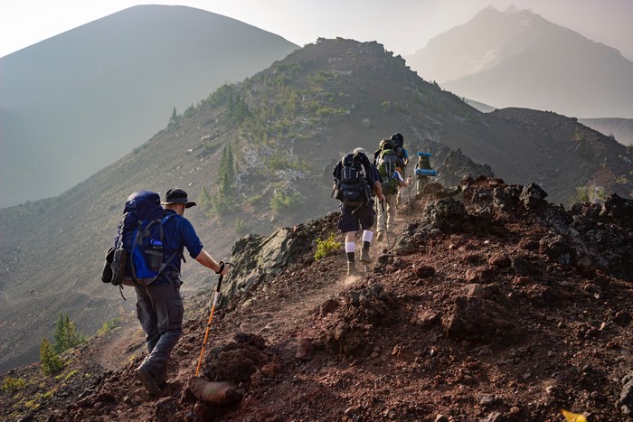 Hikers with backpacks on a mountain trail