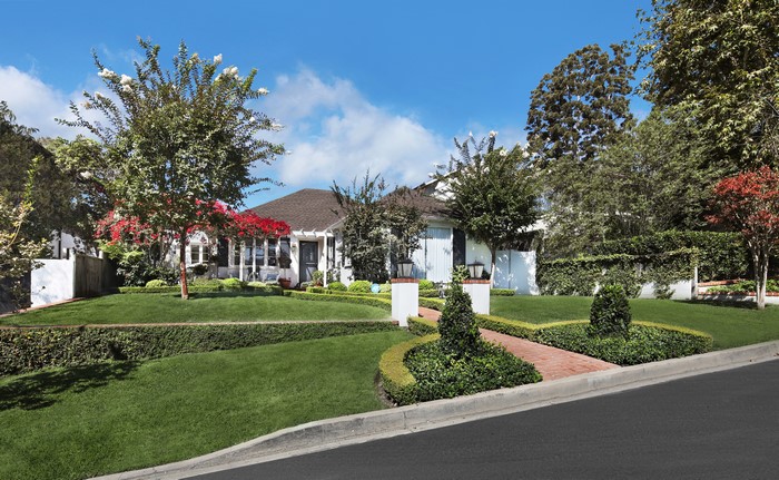 House with manicured lawn and trees in Laguna Beach, USA