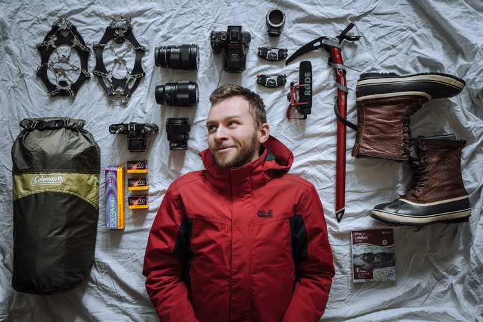 Man with climbing and photography gear