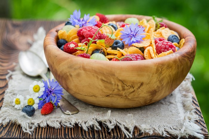Bowl of Corn Flakes with Berries and Flowers