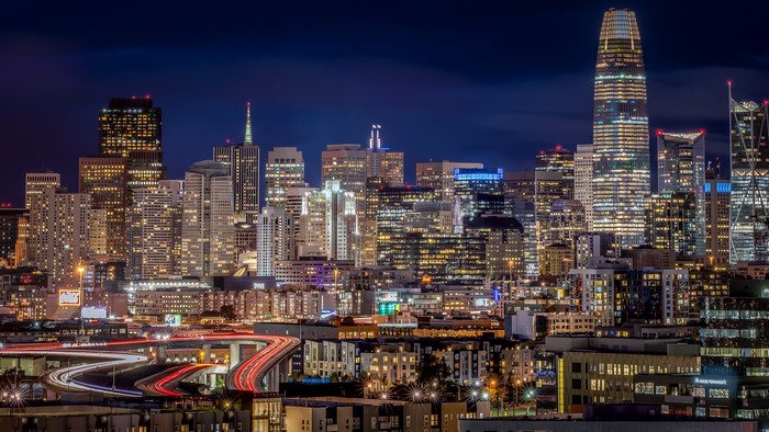 San Francisco skyline at night with light trails on roads