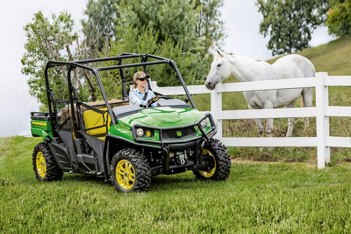 John Deere Gator XUV590i S4 with a woman and a horse