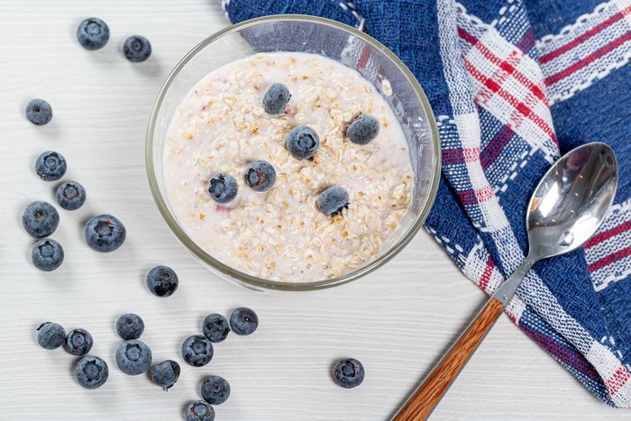 Porridge with Blueberries in a Bowl with Spoon