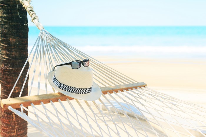 Hammock with hat and sunglasses on a beach