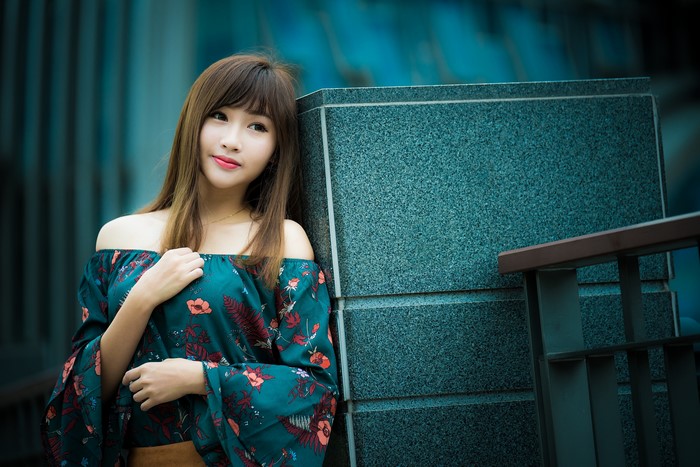 Asian woman with brown hair in a floral dress