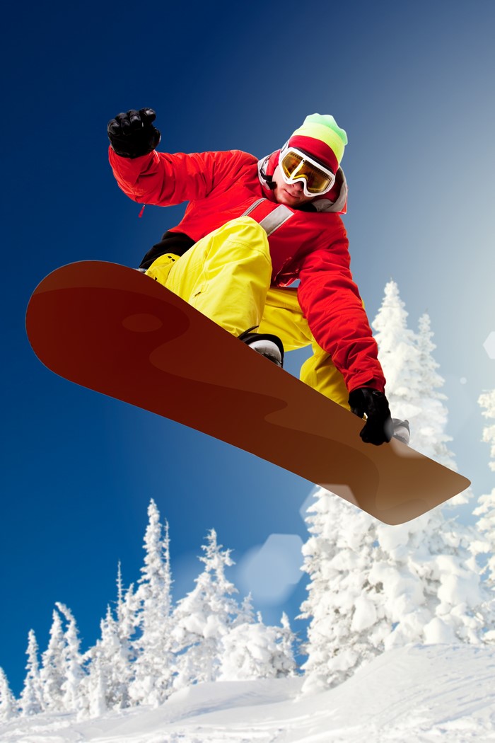 Man in red jacket and yellow pants snowboarding mid-air