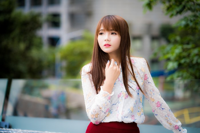 Asian woman with brown hair in a floral shirt