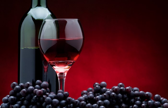 Bottle of wine, glass of wine, and grapes