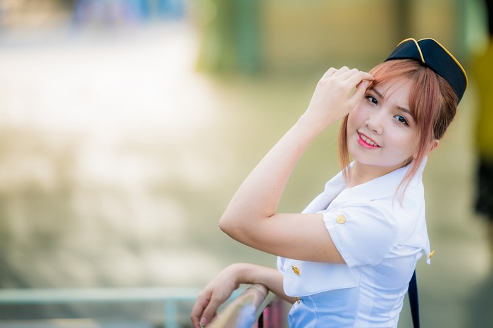 Cute Asian girl in uniform with brown hair