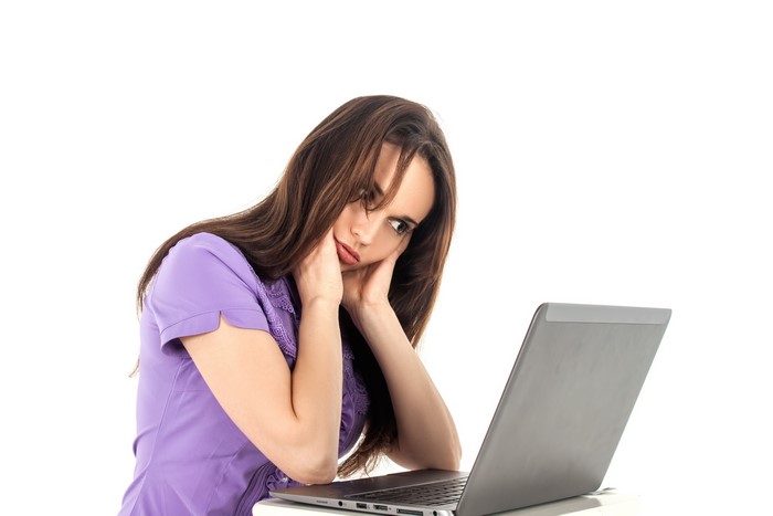 Brown haired woman with laptop on white background