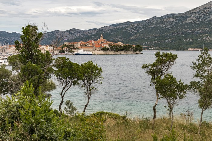 Coastal town with boats and mountains