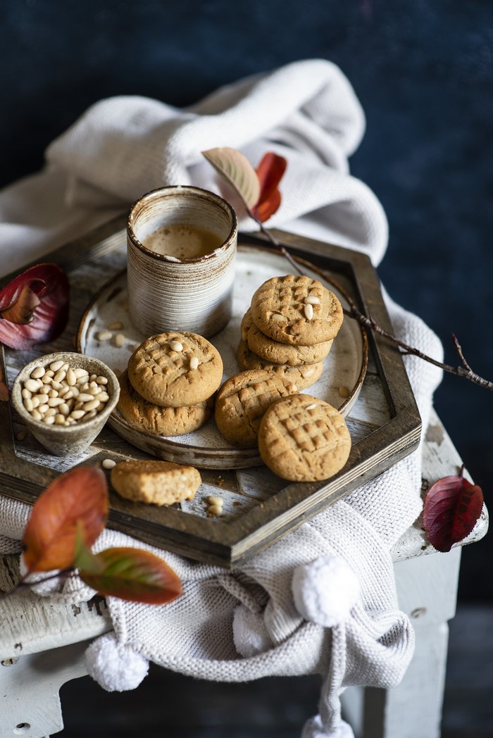 Peanut butter cookies with coffee and pine nuts