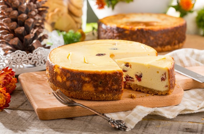 Cheesecake with a slice removed and a fork