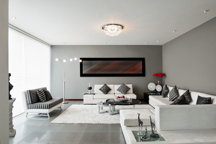Modern living room with white sofas and abstract art
