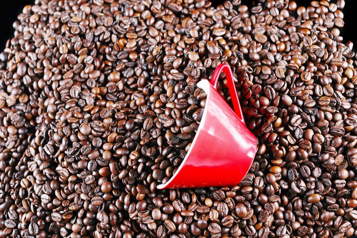 Red cup on coffee beans